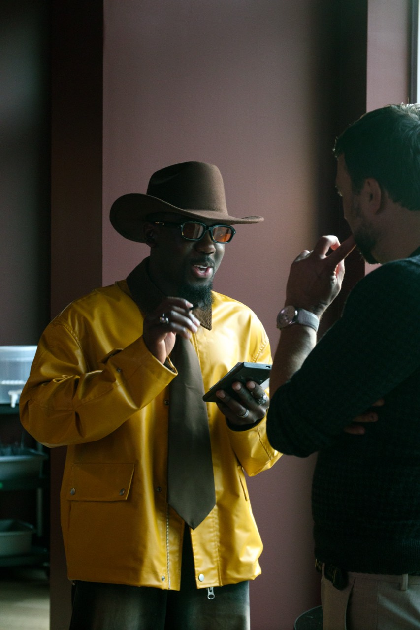 A guest in a yellow jacket in conversation