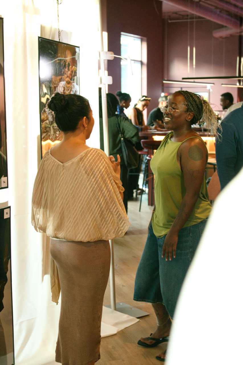 Guests discussing artwork at the exhibition