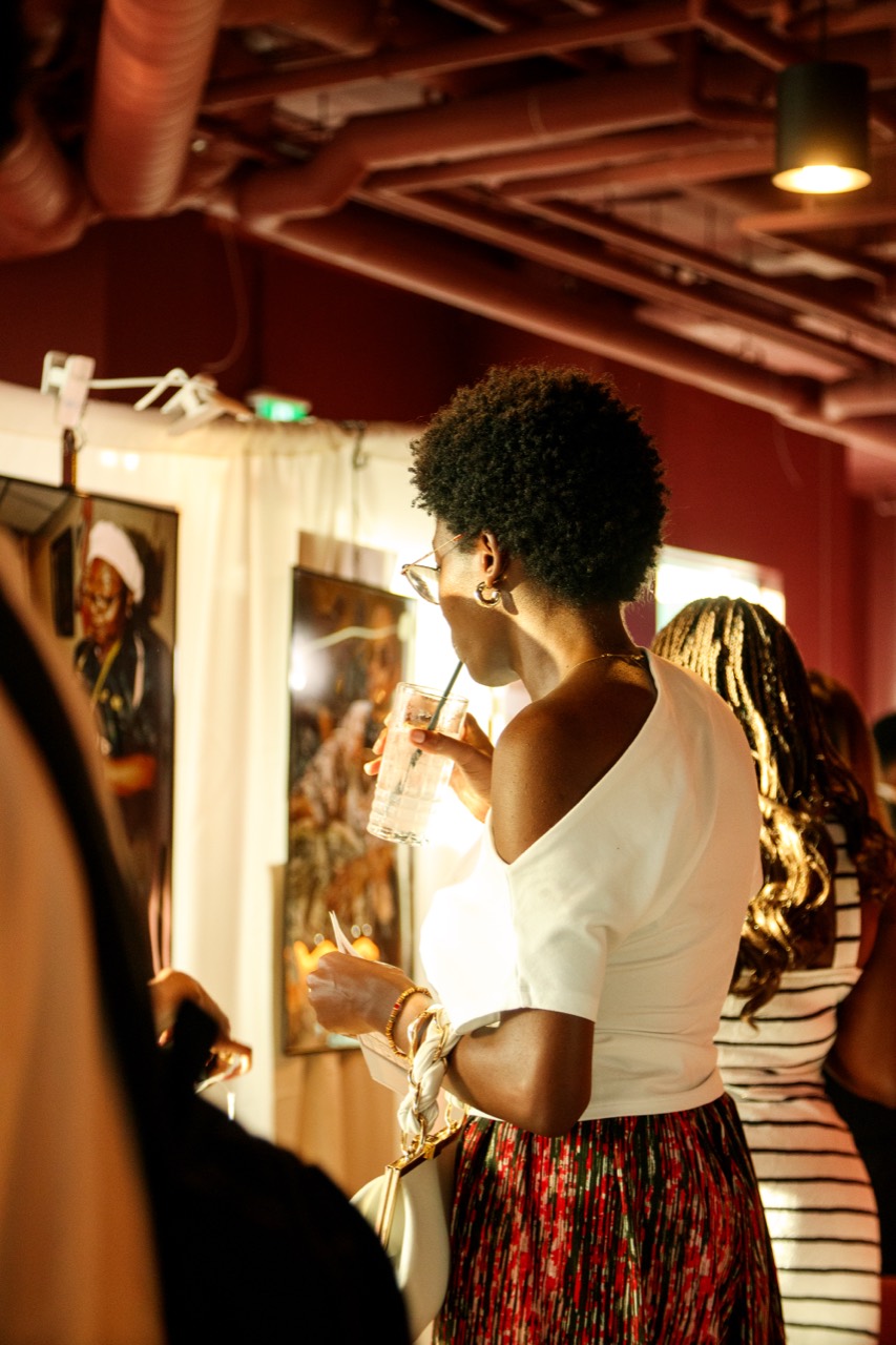 A guest viewing photography in the exhibition