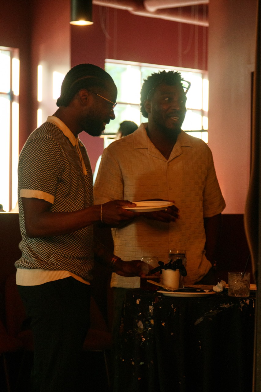 Two guests in conversation beside the interactive canvas