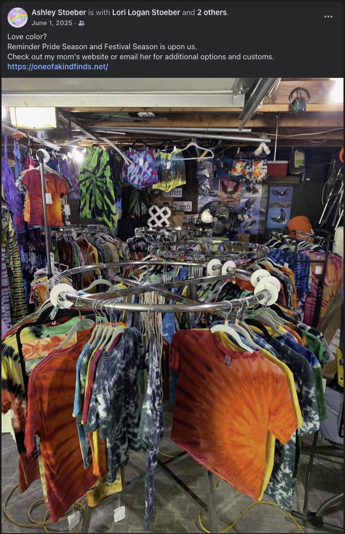 Racks filled with colorful handmade tie-dyed shirts and garments in the One of a Kind Finds workspace
