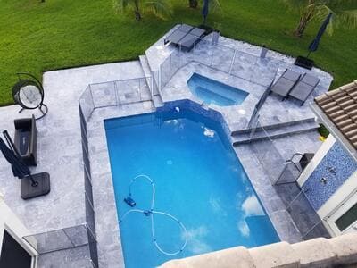 Grey elegant pool with a tanning ledge