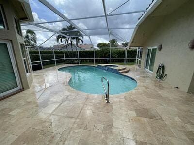 small infoor pool with travertine floor