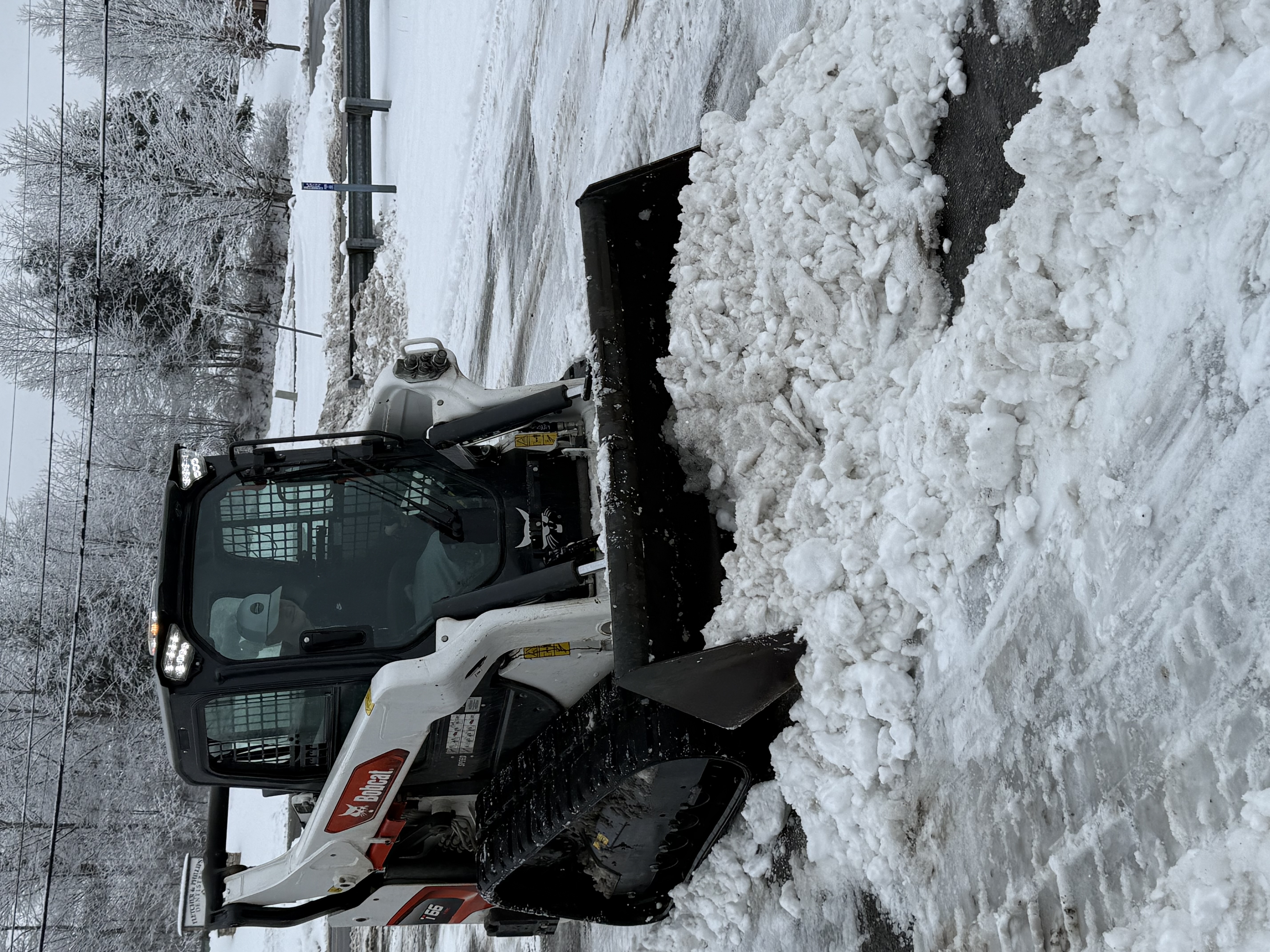 Heavy equipment clearing snow from roads and access points in winter