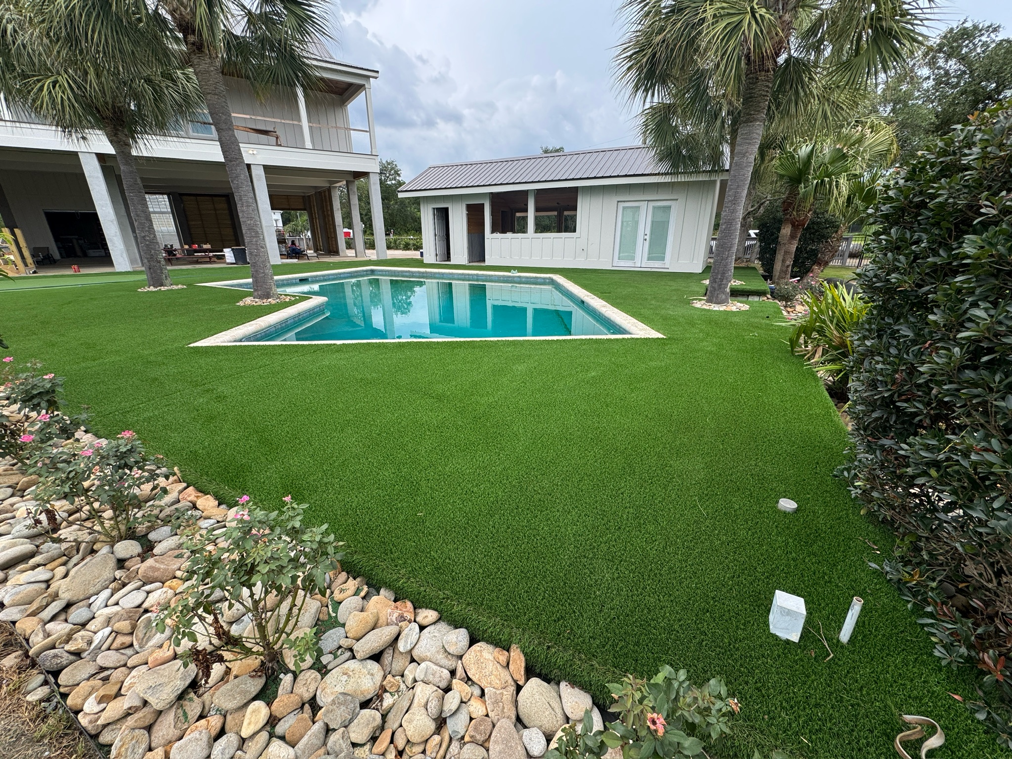 Artificial turf surrounding a pool and residential patio