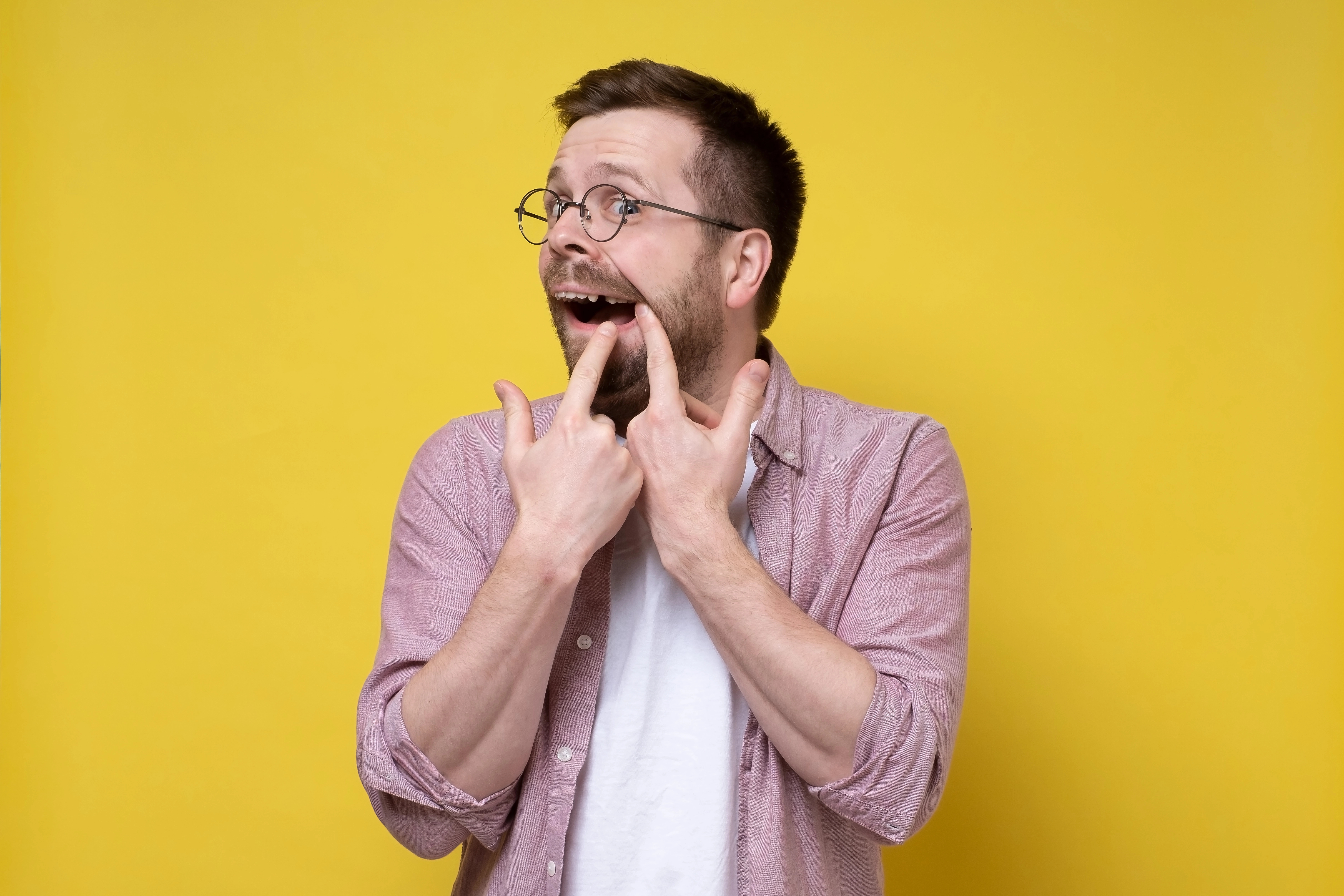Oraco Dental patient flossing to help prevent dental emergencies