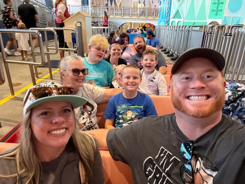 Chris, Adrianne and their kids on a ride at Disneyland