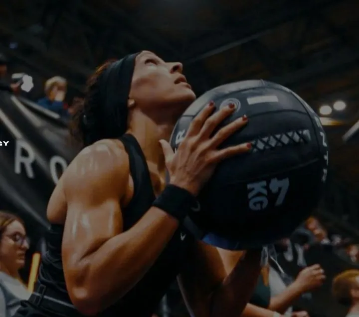 JST MVE member carrying a medicine ball at HYROX