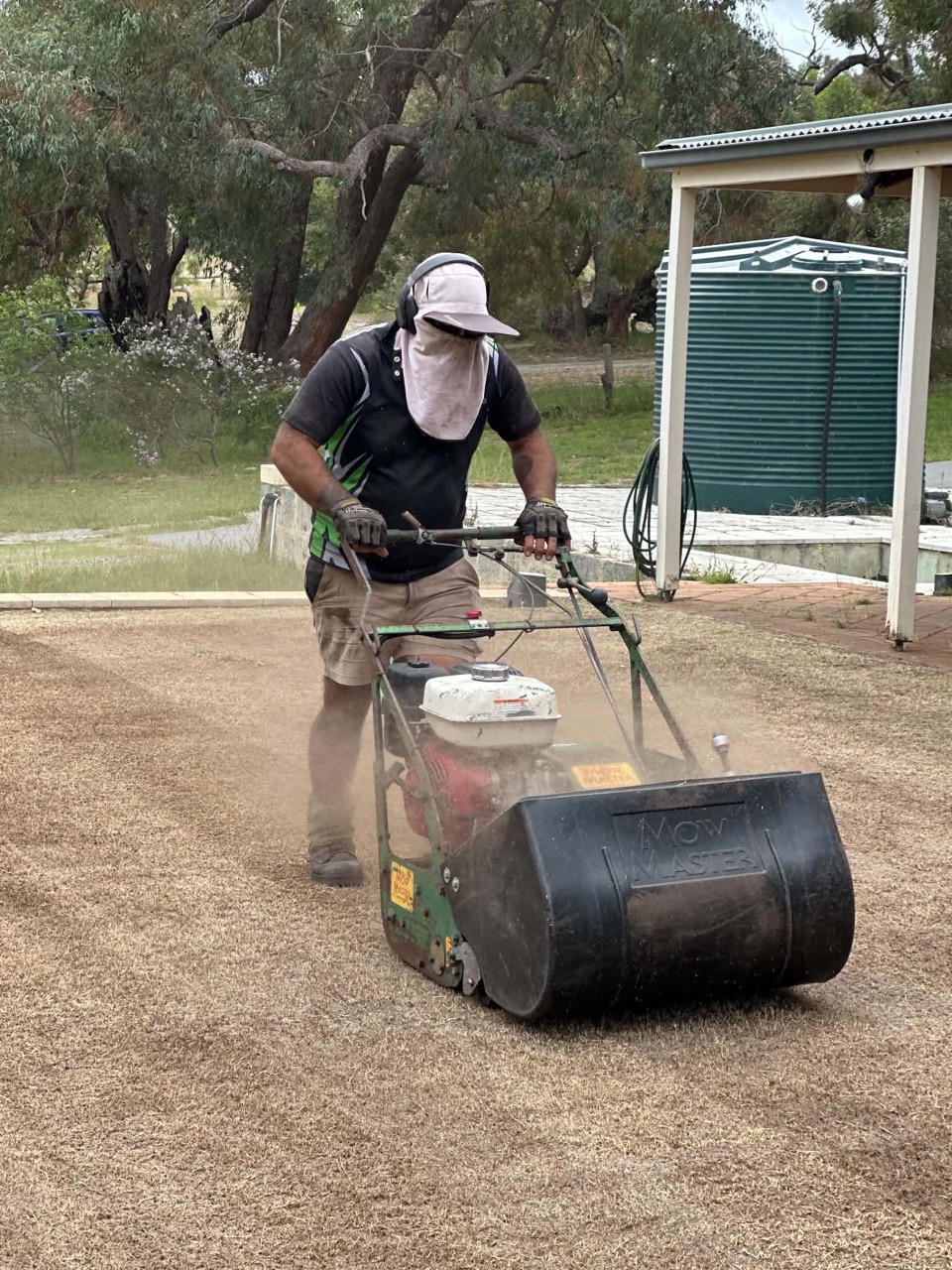 A lawn partway through vertimowing by Cotton's Mowing