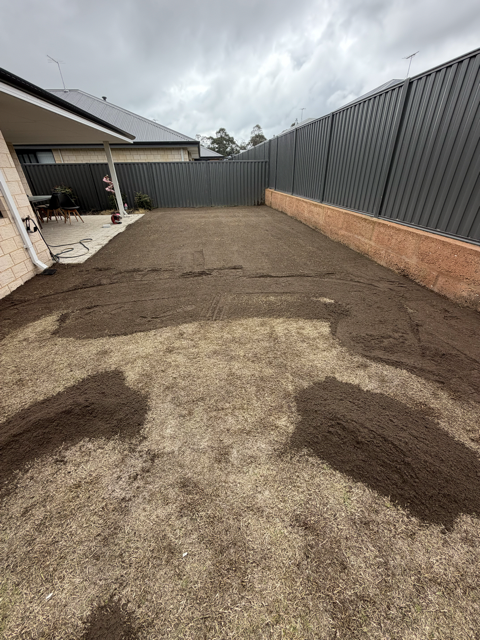 Top dressing material being applied to a lawn by Cotton's Mowing