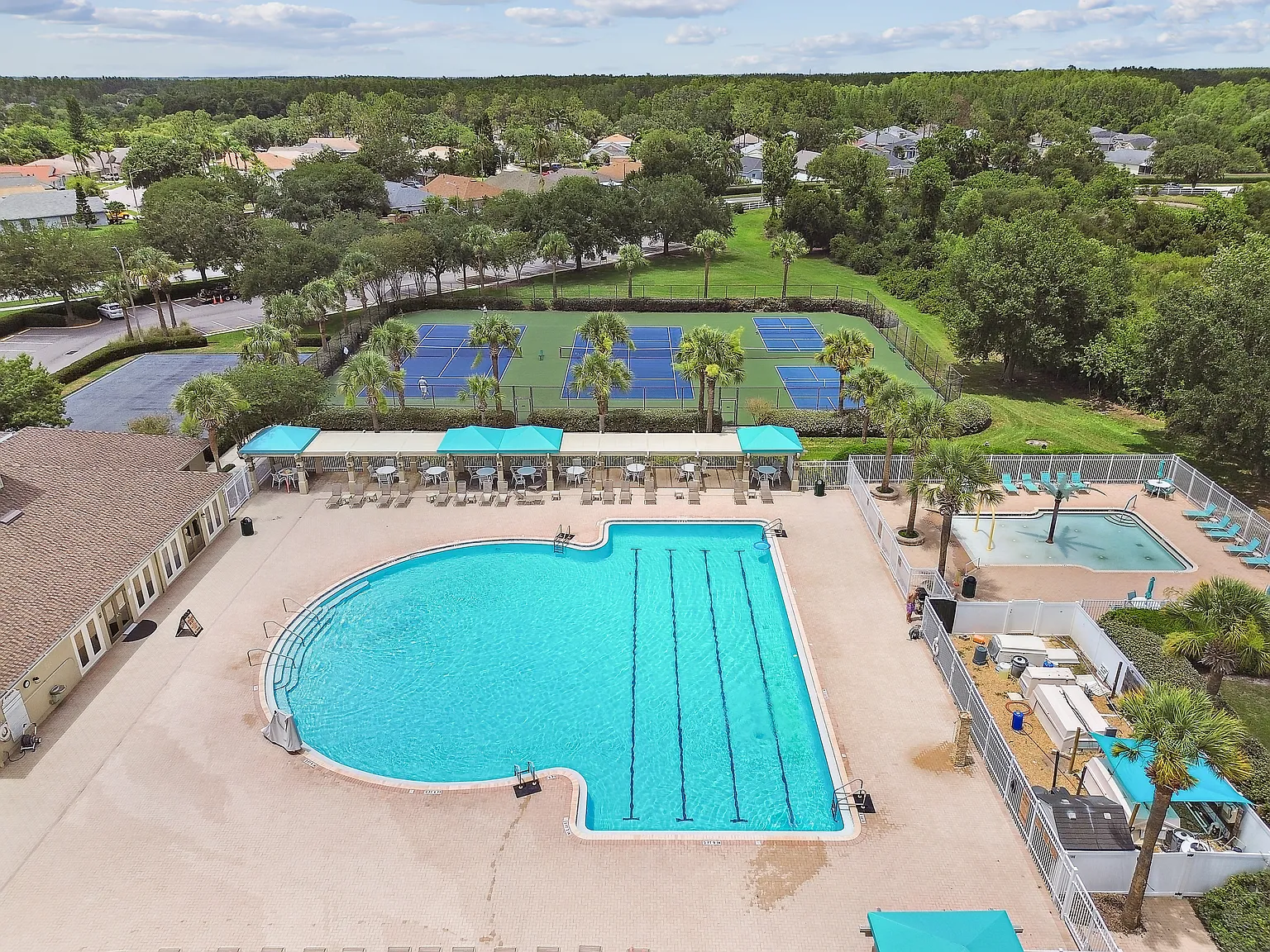 Community pool and tennis courts at 3125 Ashmonte Dr, Land O Lakes FL