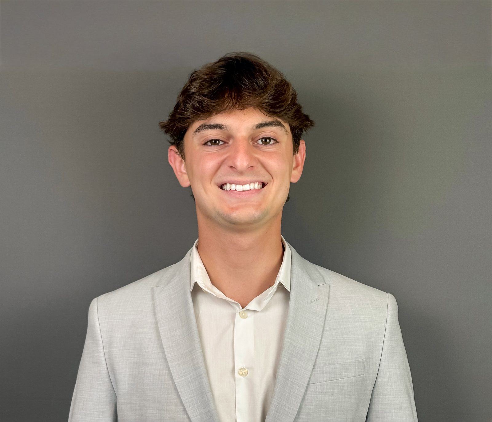 Ty Ippolito, marketing and data analytics student at Samford University, in a light grey suit