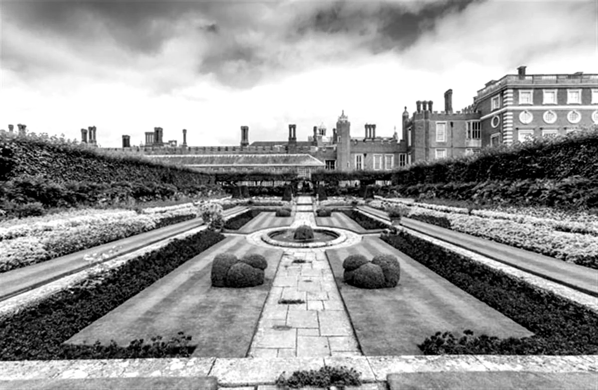 The formal sunken gardens at Hampton Court Palace, with the Tudor palace and its ranks of chimney stacks rising behind