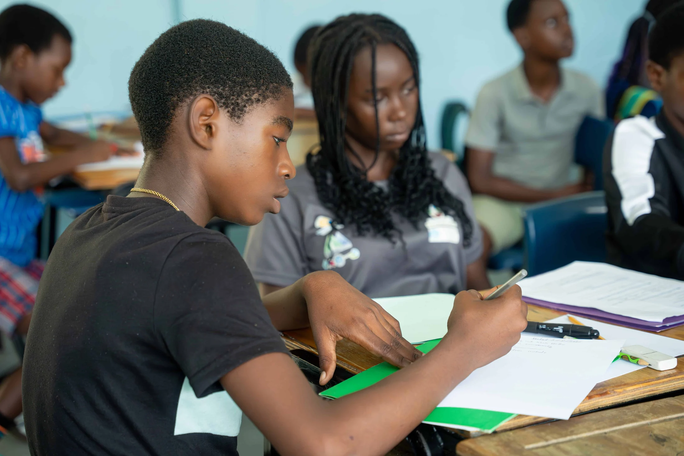 Students work at their desks in a classroom