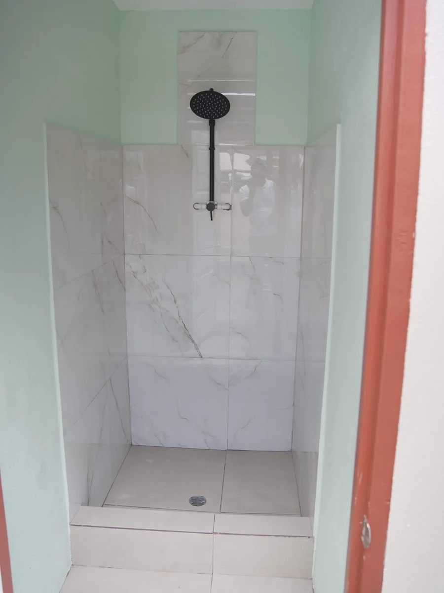 The refurbished school washroom: a tiled shower stall