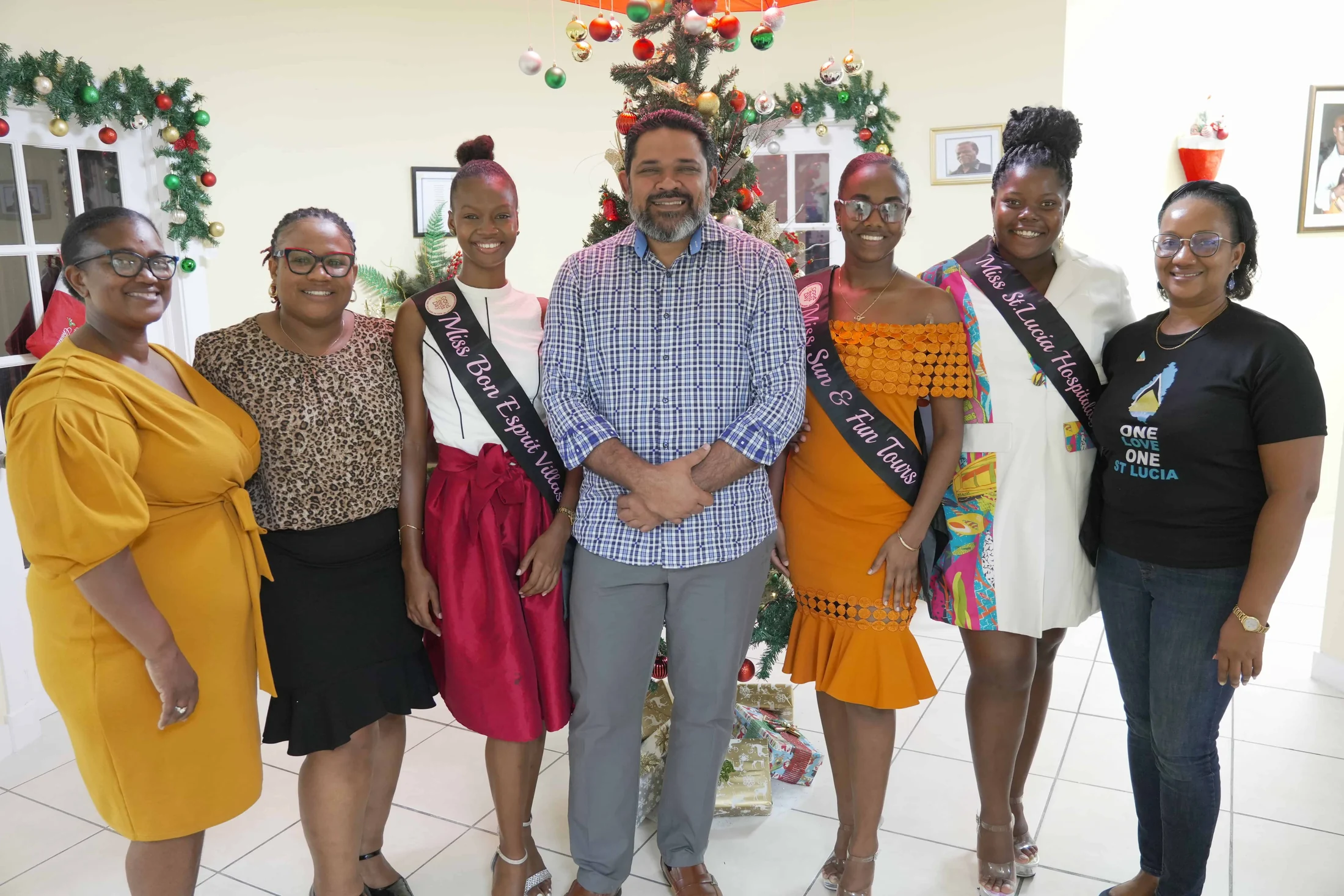 Pageant queens in sashes and SLHTA staff at a community Christmas event