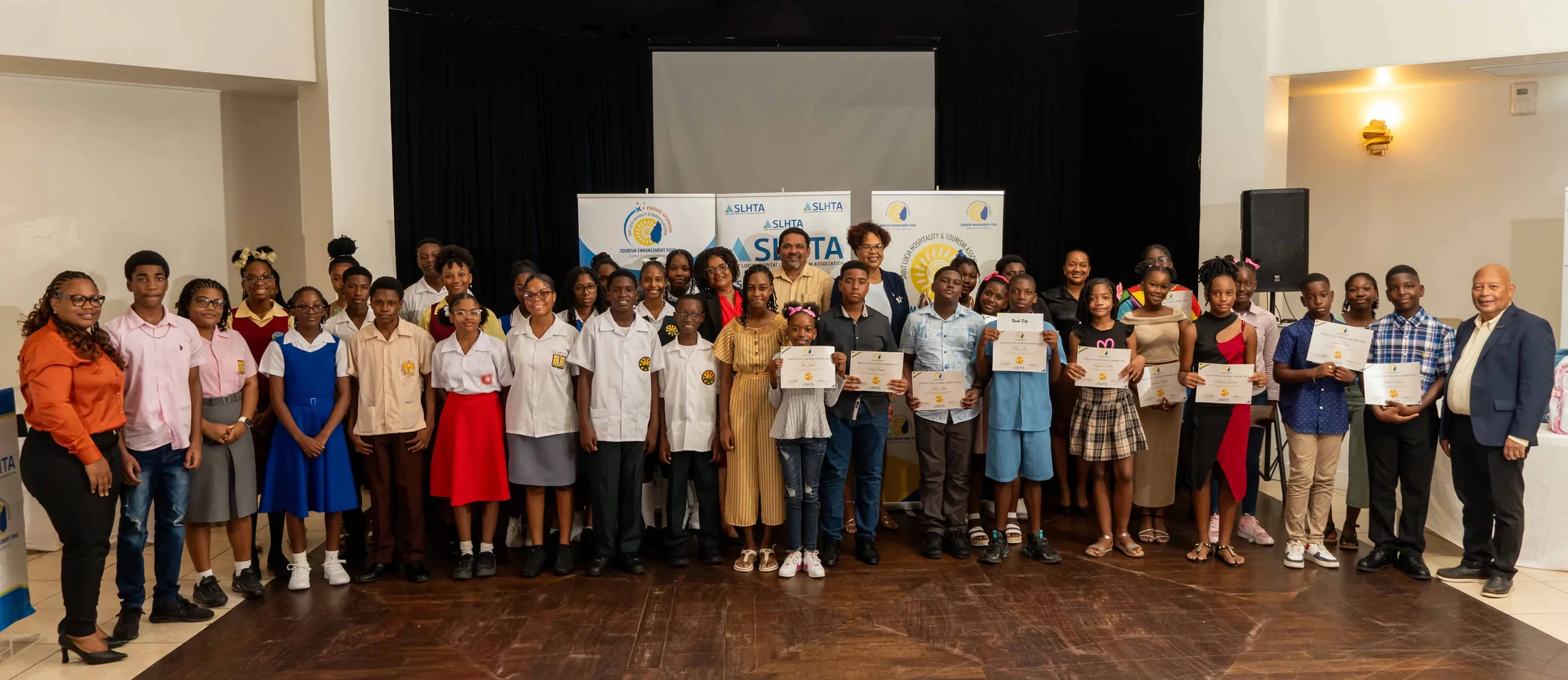 Eileen Paul Scholarship recipients hold their certificates with SLHTA and TEF representatives