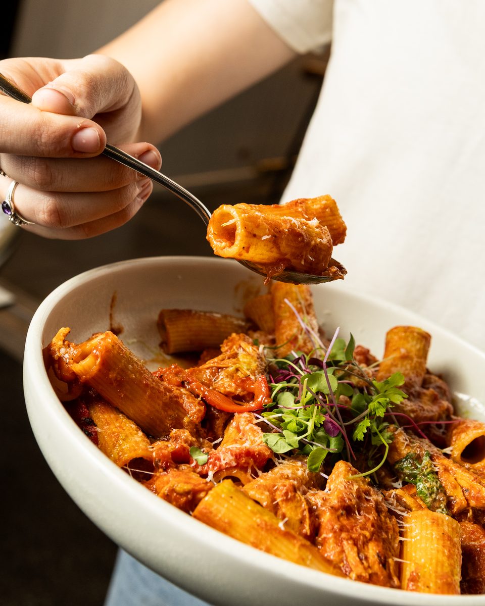 Chicken and chorizo rigatoni lifted on a fork