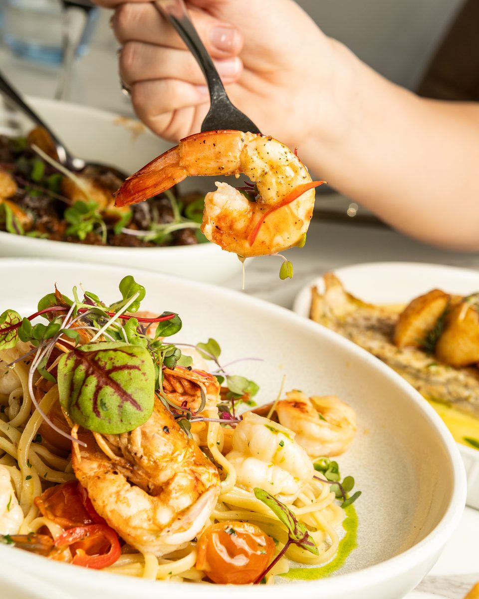Garlic Chilli Prawn Linguine, a prawn lifted on a fork