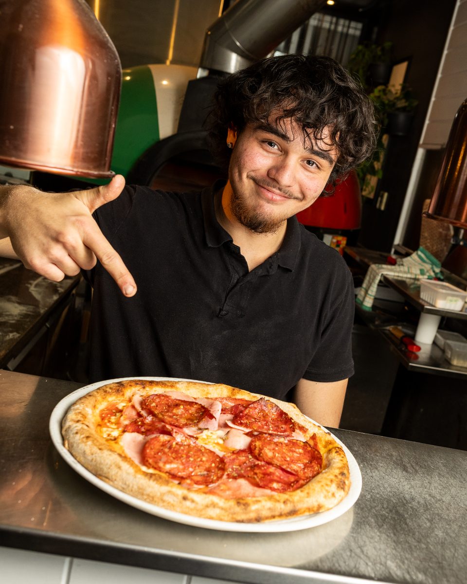 Rocky's Italian chef with a Meatlover Italia pizza at the pass