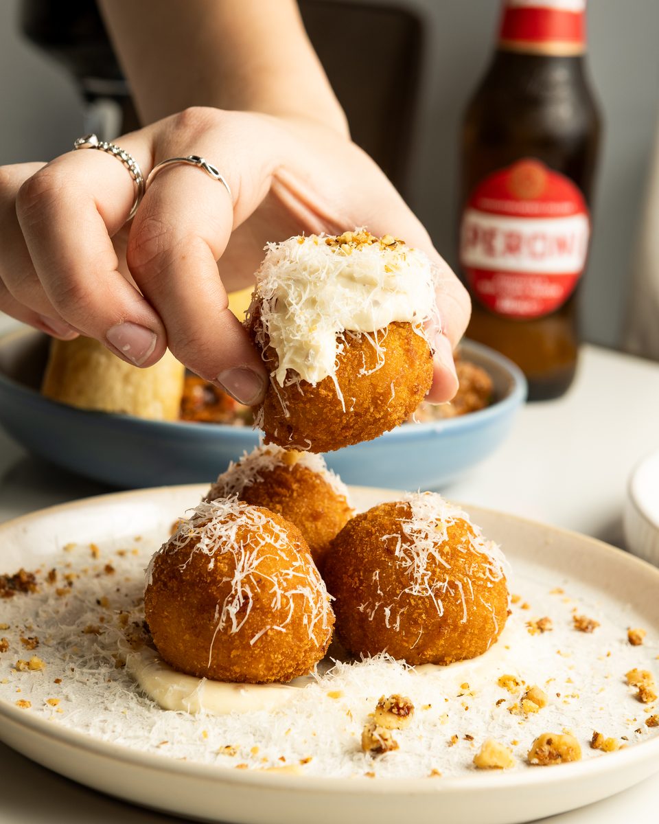 Roasted pumpkin arancini lifted from the plate