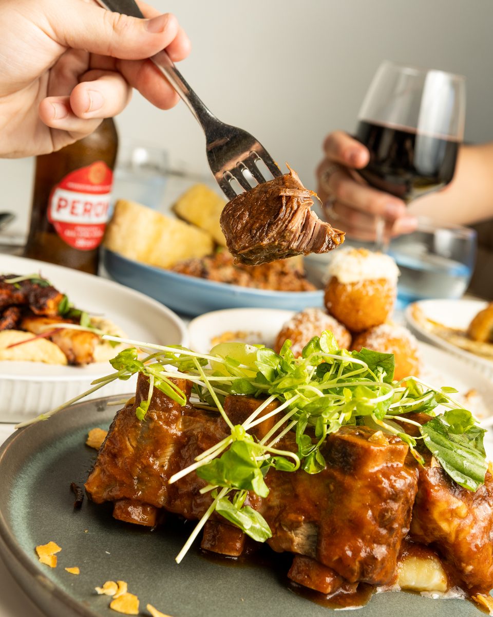 Slow cooked beef rib with a glass of red wine