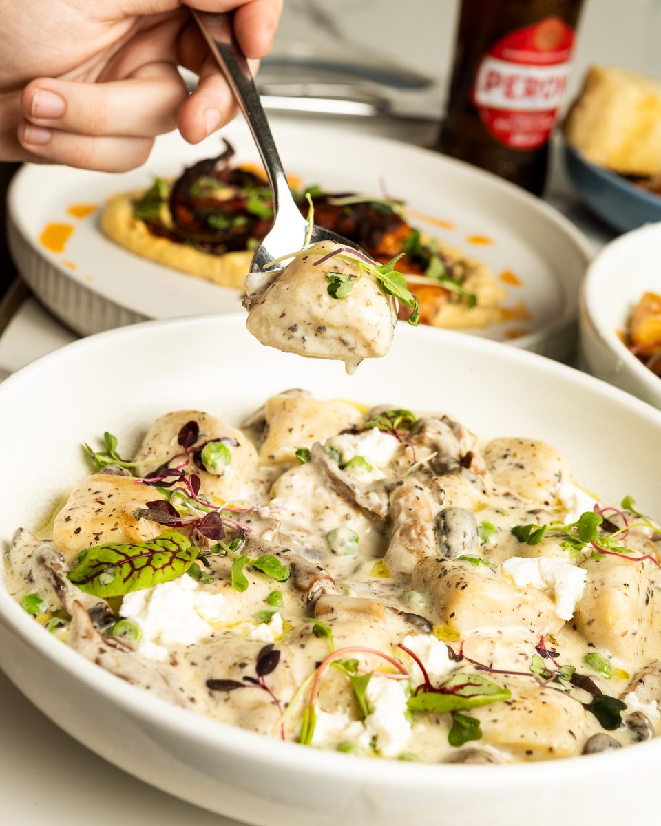 Truffle mushroom gnocchi lifted on a spoon