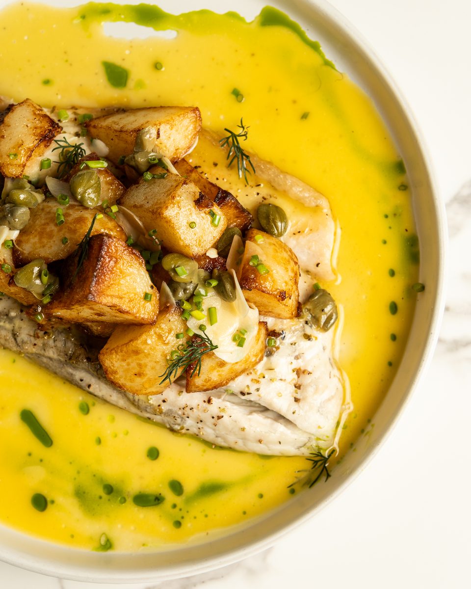 Woodfire baked barramundi with crispy potatoes and capers