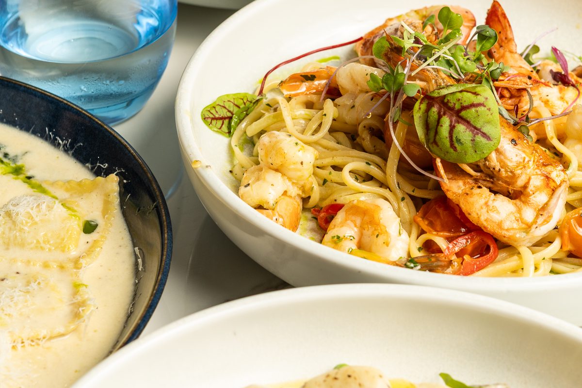 Garlic Chilli Prawn Linguine beside Spinach & Ricotta Ravioli and gnocchi on a Rocky's Italian table