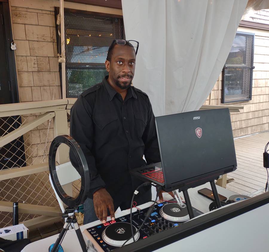 Ron O'Neale at his DJ setup at an outdoor event