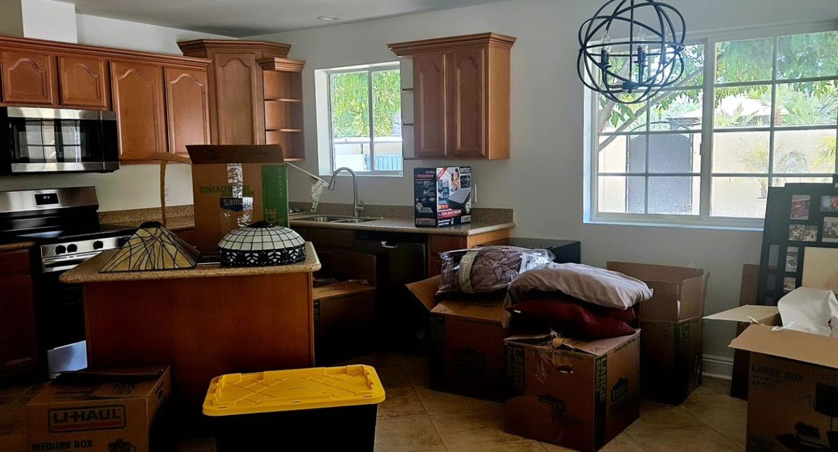Before: guest house kitchen full of boxes