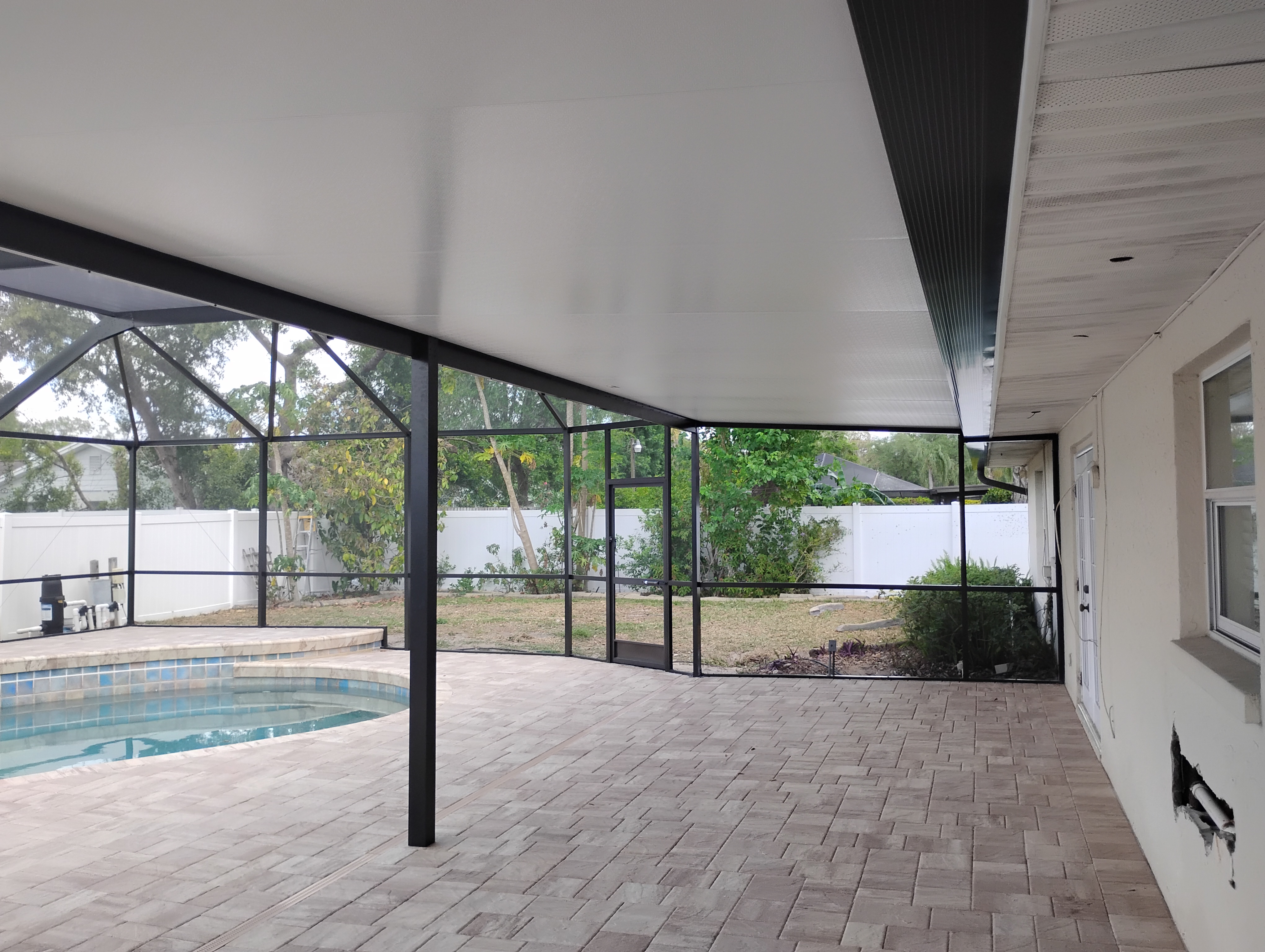 Patio cover and solid roof enclosure in Tampa Bay, FL by Screen Boss