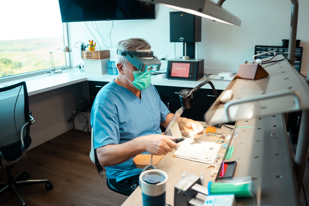 An Elite lab technician at the bench in the in-house dental lab