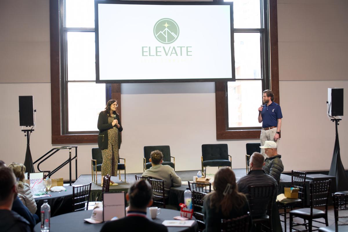 The Elevate mark on screen at the front of the room