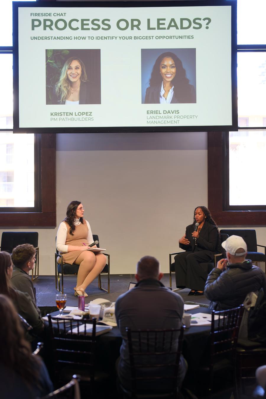 A panel session with the audience seated at round tables