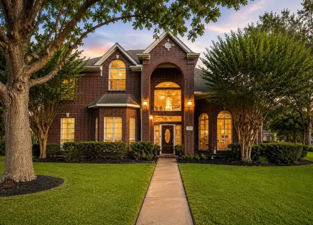 Two-storey brick home at dusk