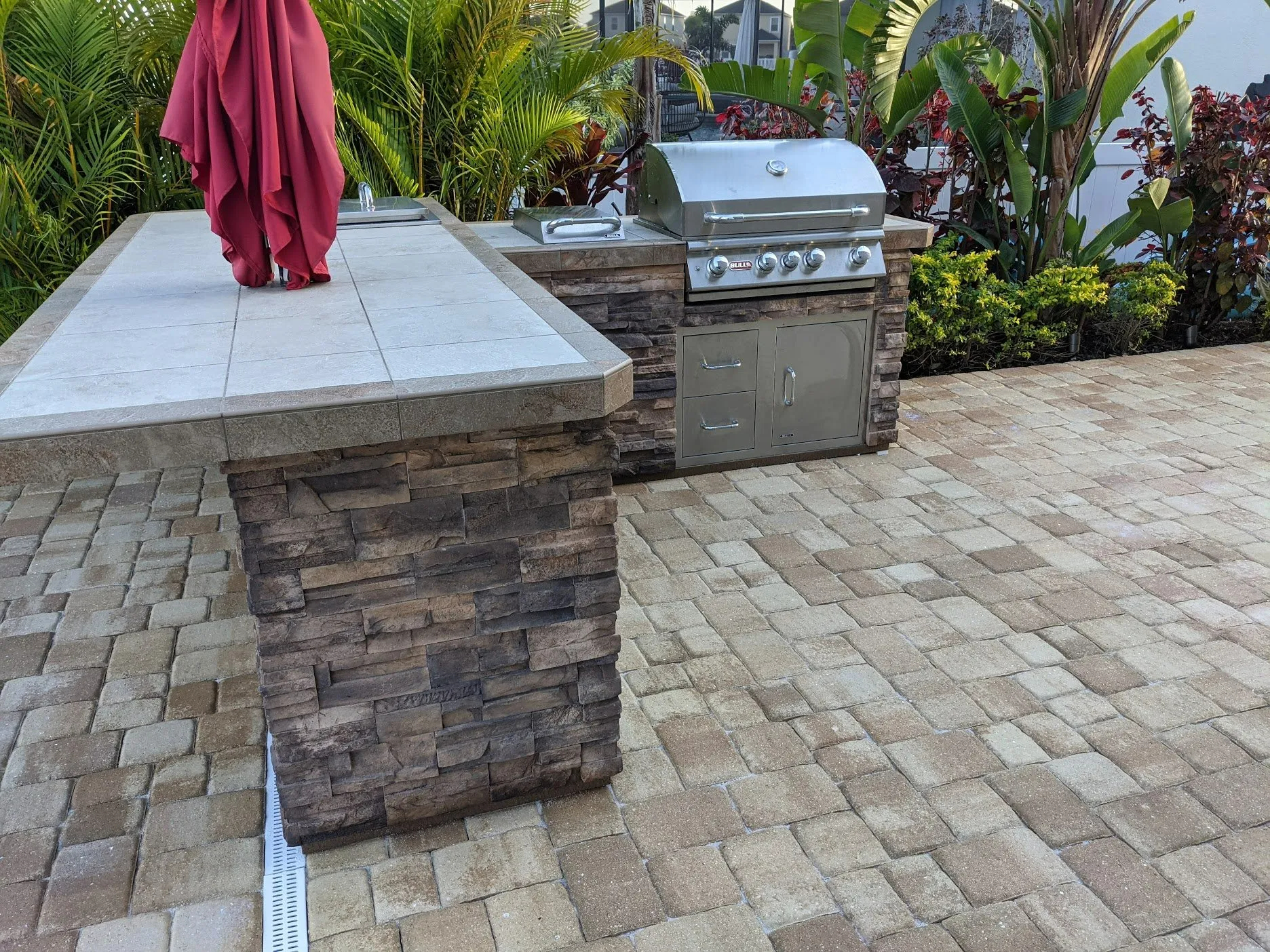 Attractive brick paver patio with grill