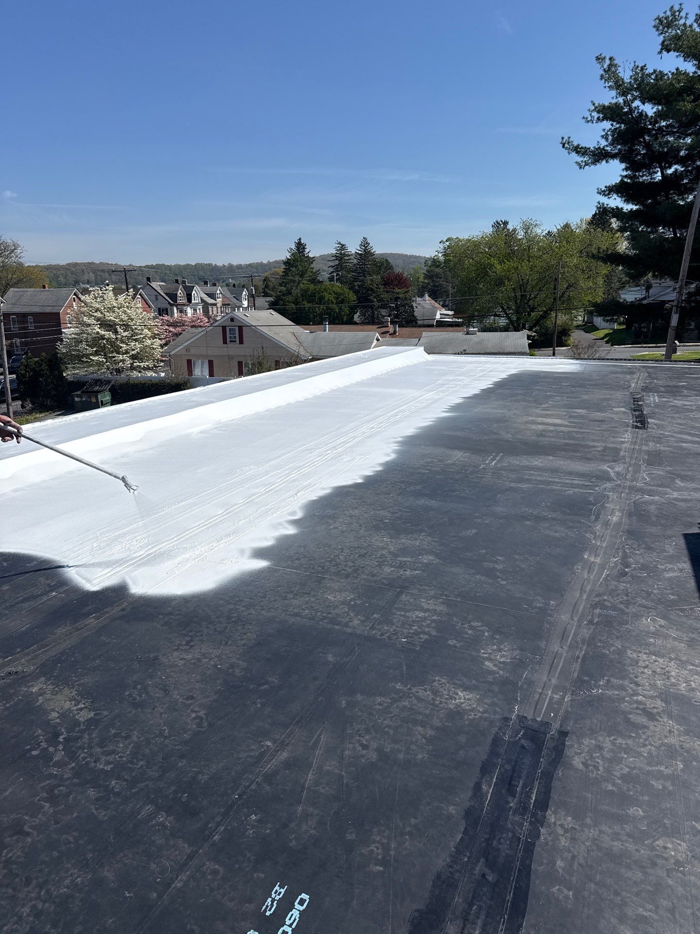 A new white silicone coating being applied to an EPDM roof in Central Pennsylvania. A new white silicone coating being applied to an EPDM roof in Central Pennsylvania.