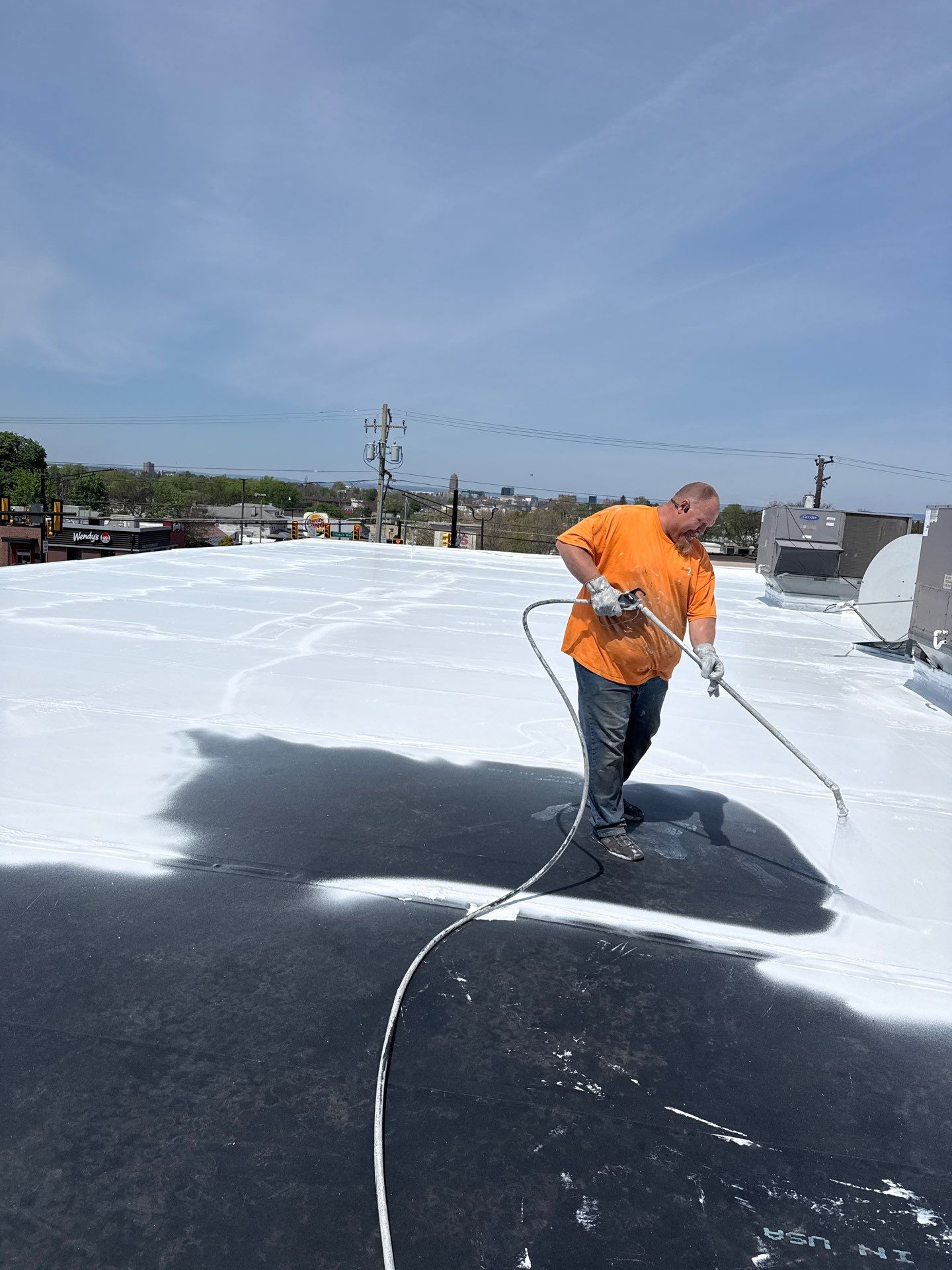 Tim Schultz applying a fresh roof coating to a Dollar General in Central PA. Tim Schultz applying a fresh roof coating to a Dollar General in Central PA.