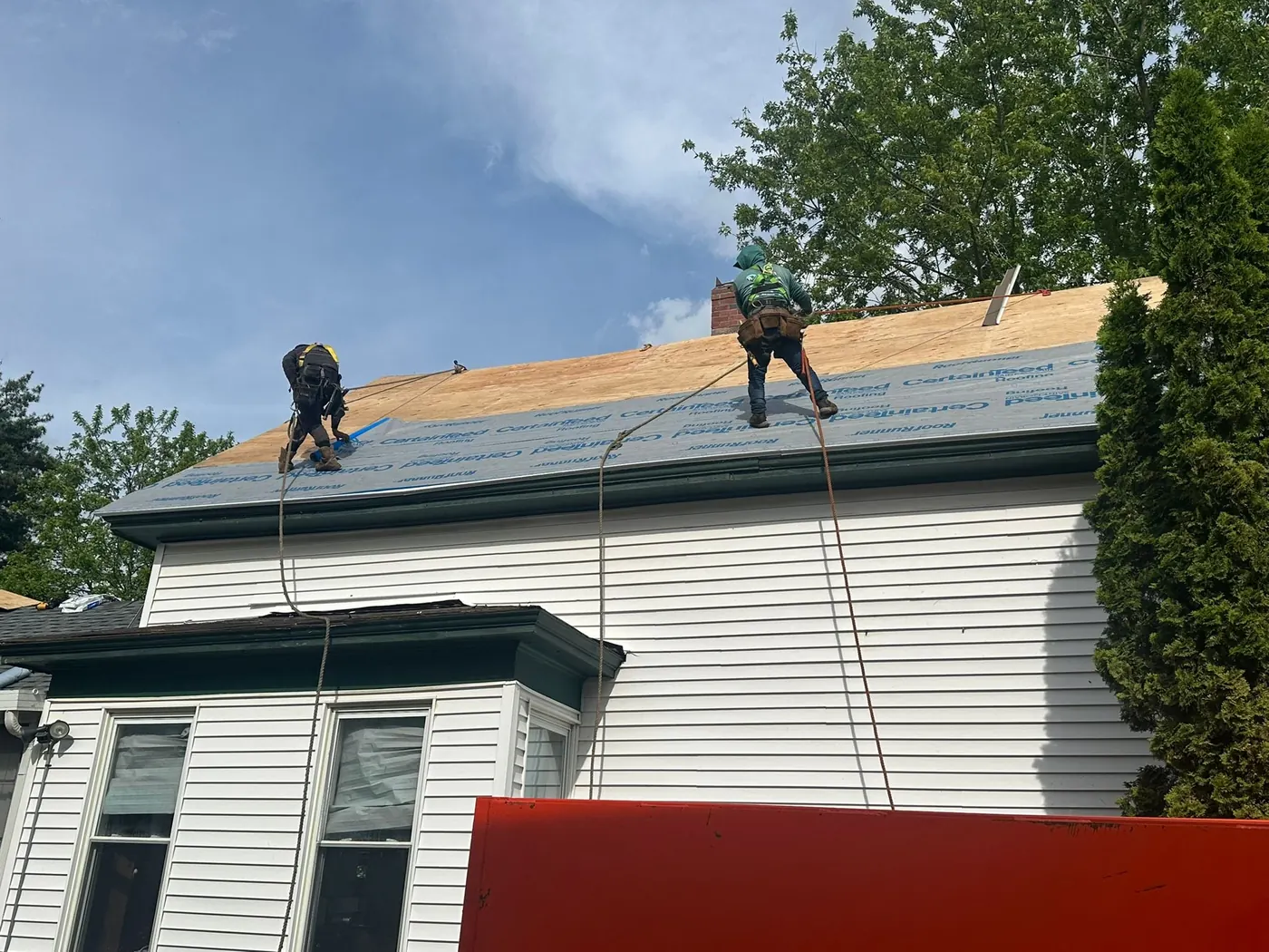 Evolution Pro Builder crew working on an exposed roof deck during a replacement