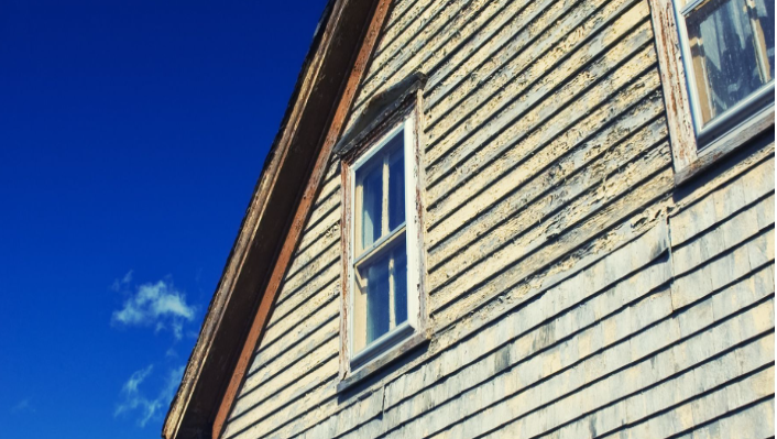 Peeling and cracking paint on a wall showing a home needs repainting