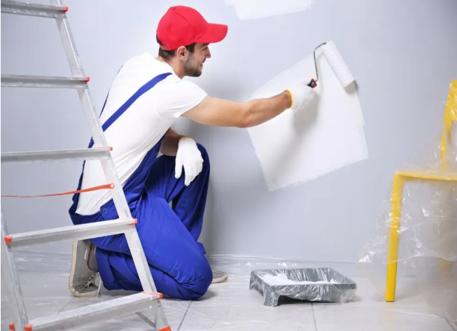 Professional painter rolling an even coat of paint onto a wall