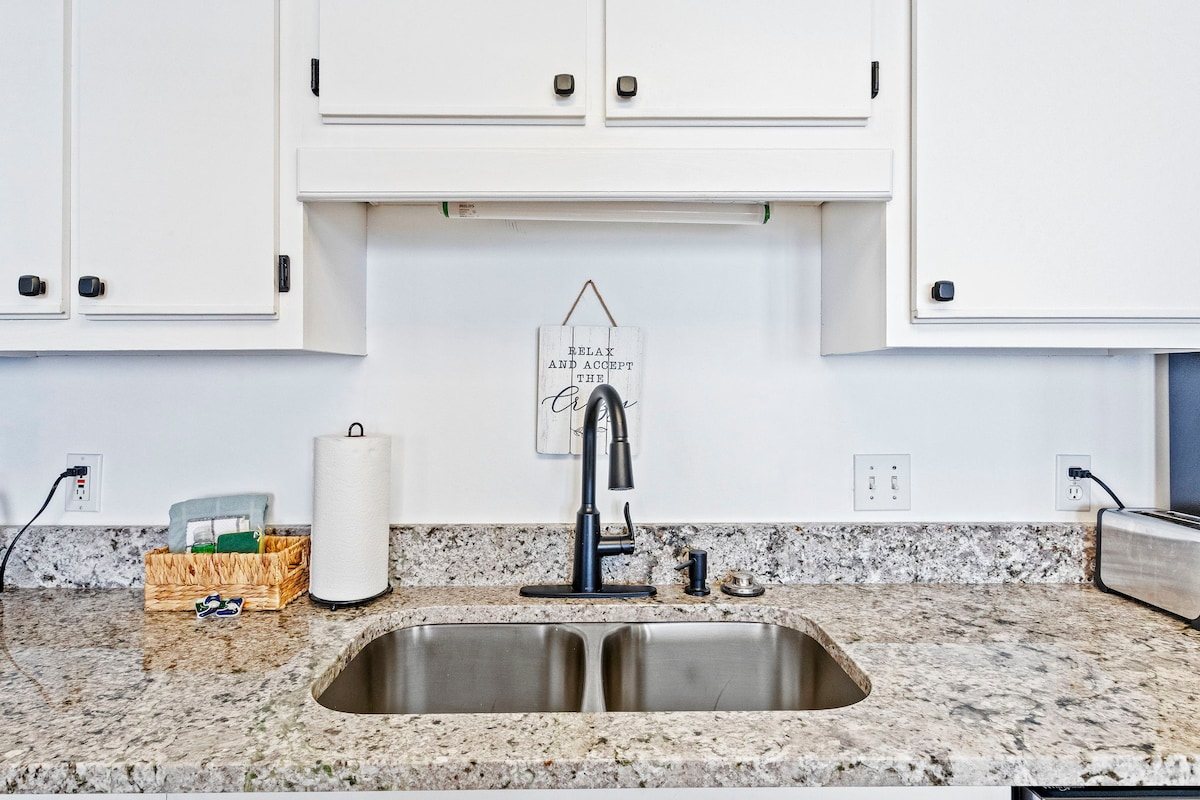 Wash the sand off a cooler in a double sink deep enough to actually use