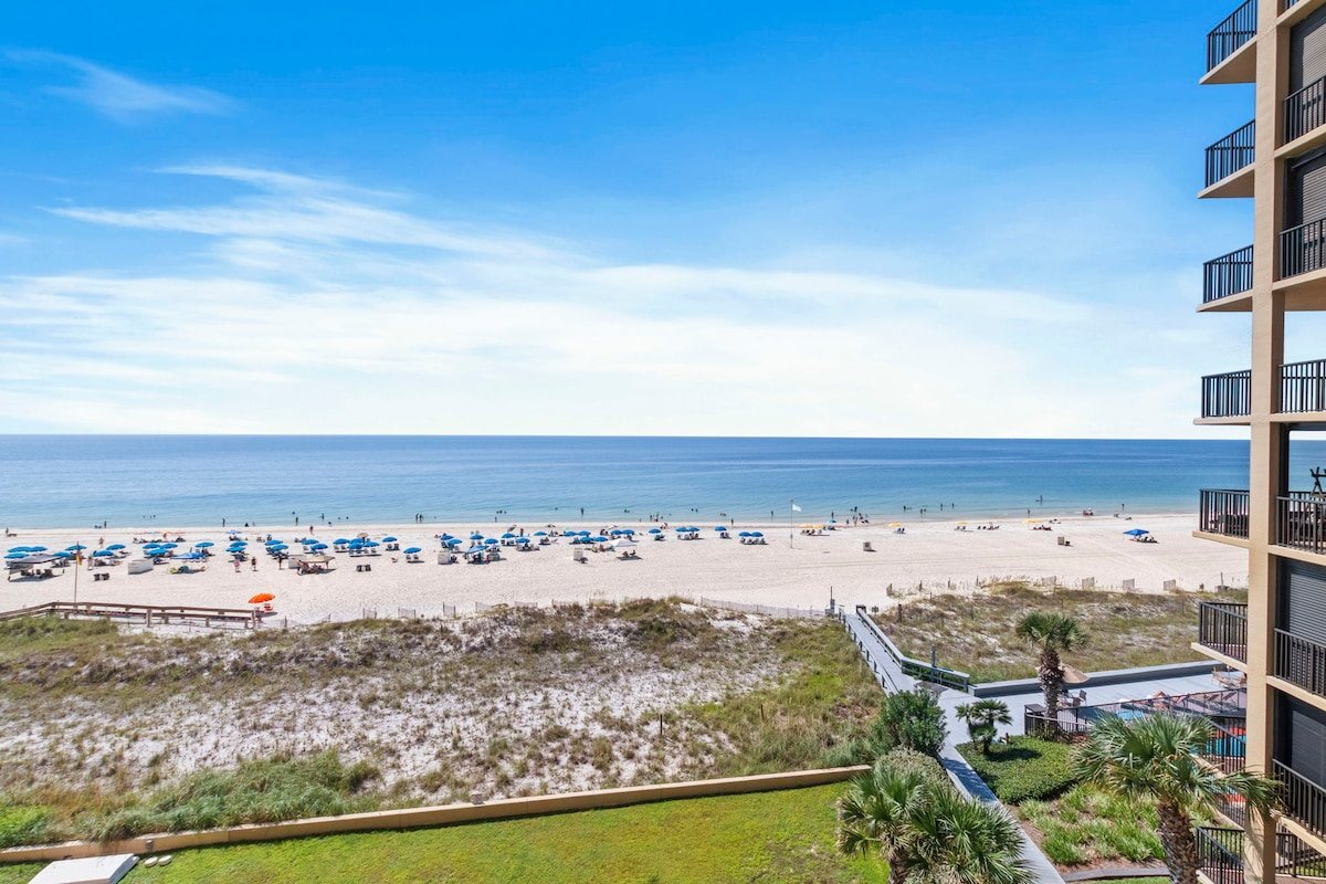 Watch the umbrellas go up in the morning from high above the sand