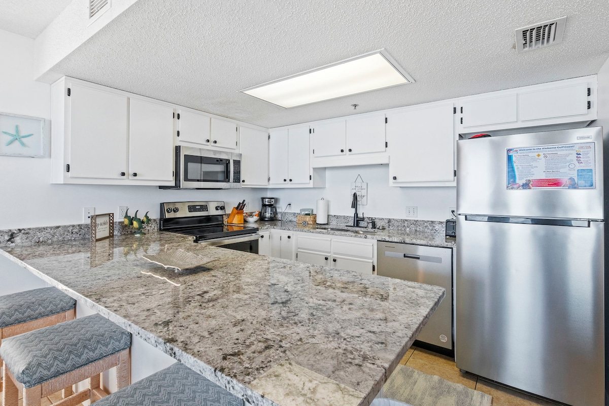 Kitchen with granite counters and a full-size range