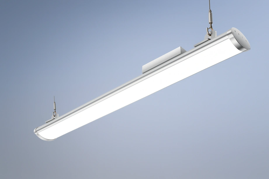 Photoreal 3D render of FYT Lumen Plus Linear High Bay LED Light, aluminum housing with frosted diffuser, suspended cable mount, clean gradient background.