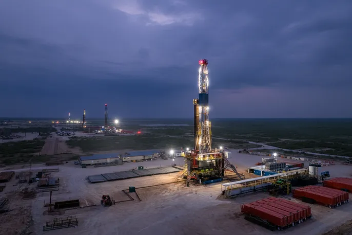 Midland Basin, West Texas land rig at dusk, container rooms and drill floor lit, IR Series LEDs.