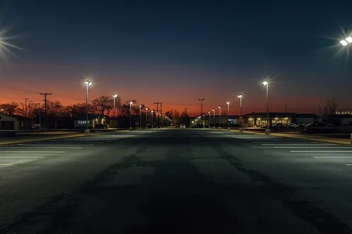 Anchorage port with cranes and Chugach Mountains in winter twilight, cool LED facility lights, marine and cold storage lighting service