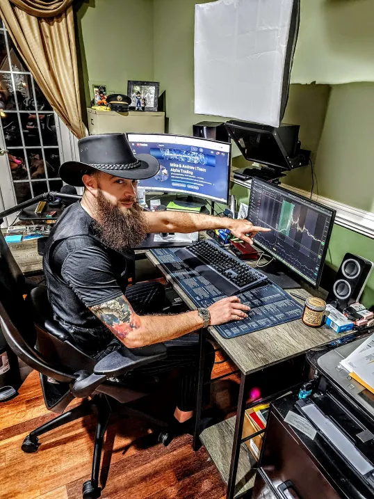 Mike Poarch trading stocks and futures at his multi-monitor desk