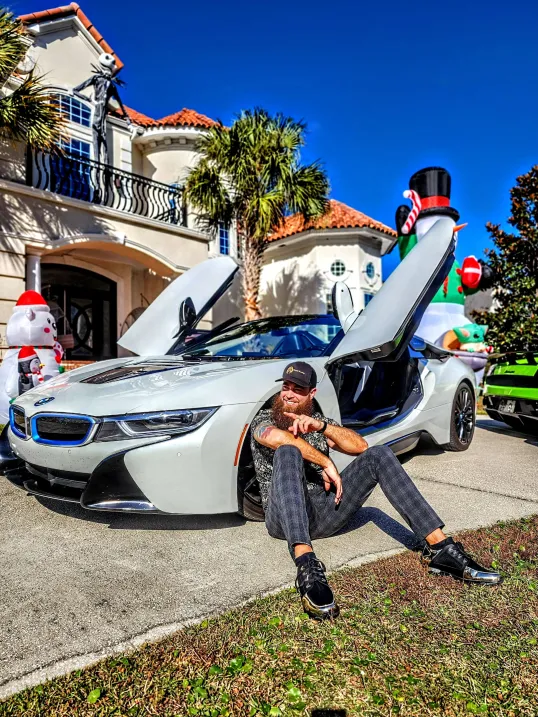 Mike Poarch outside his home with a BMW i8